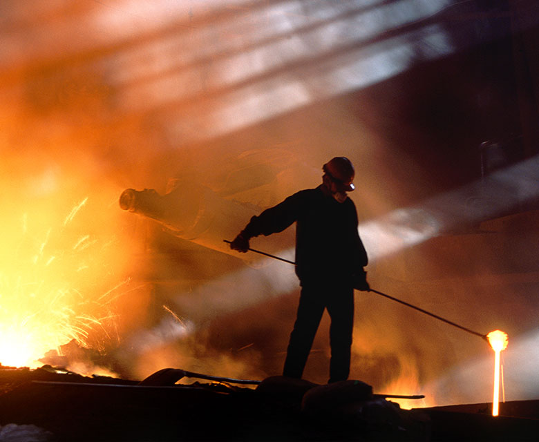 Man pouring molten steel.